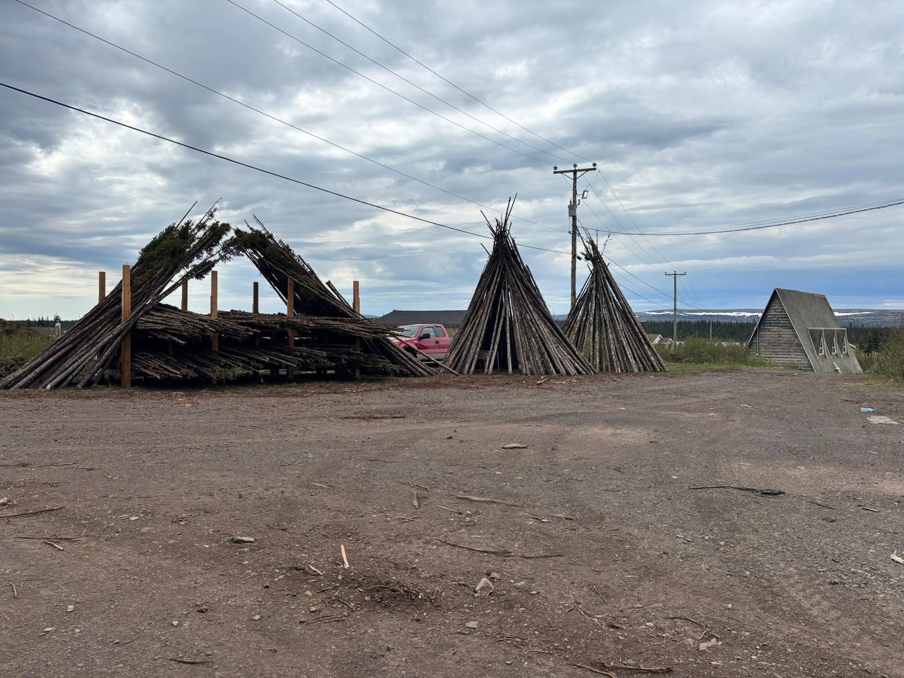 Wood poles and traditional structures on the site.