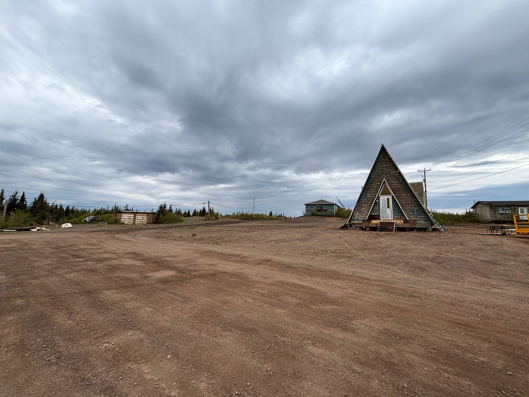 Triangular building and open ground before installation.
