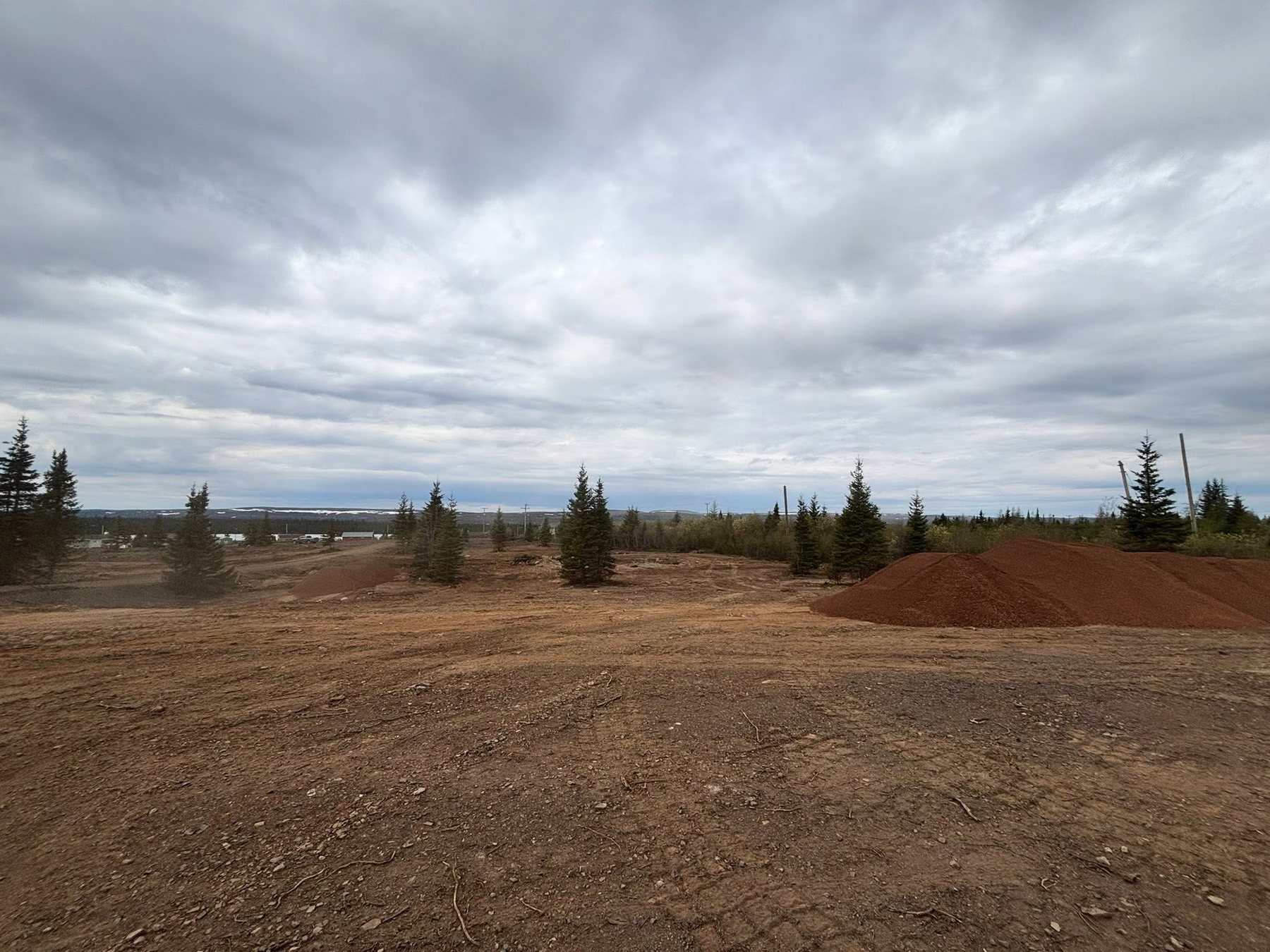 Open ground with preparation materials in the distance.